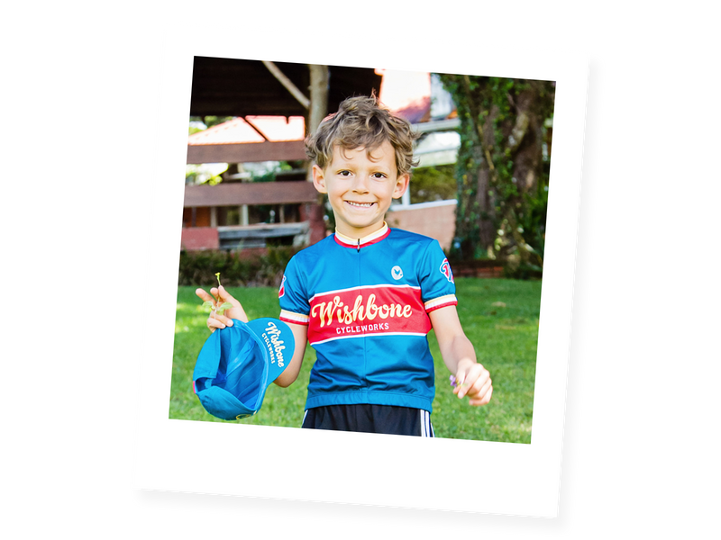 young boy in blue cycling jersey